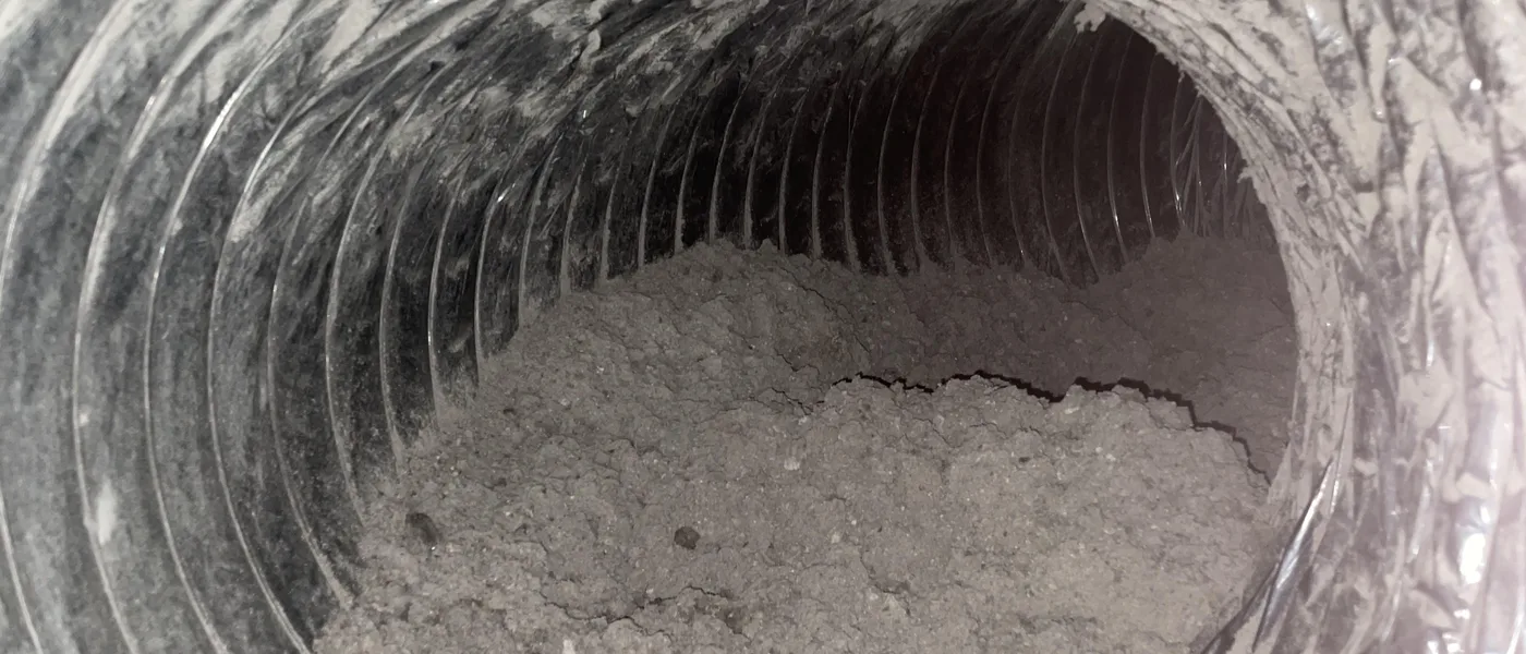 Dust and lint-clogged air duct before air duct cleaning Las Vegas service